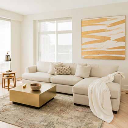 bright gold and beige living room with wood and linen furniture
