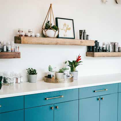 open shelf kitchen with plants on the wood shelves