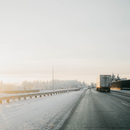 A moving truck on a snowy road in the winter