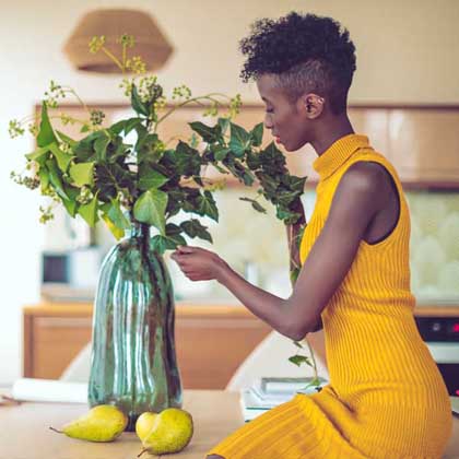 woman pruning lemon trees in her home