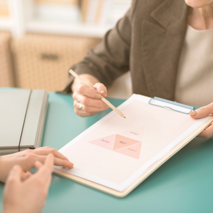 therapist holding a clipboard and a pencil