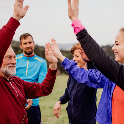 people high fiving with mountains in the background