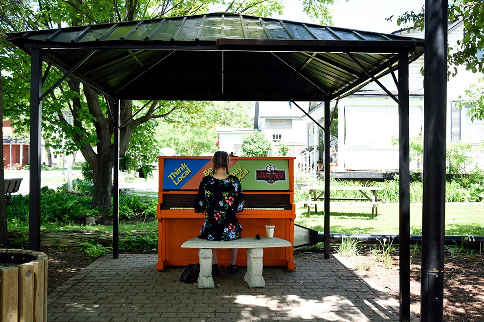 Girl playing music in Manotick Village - near Mahogany, Manotick a community by Minto Communities