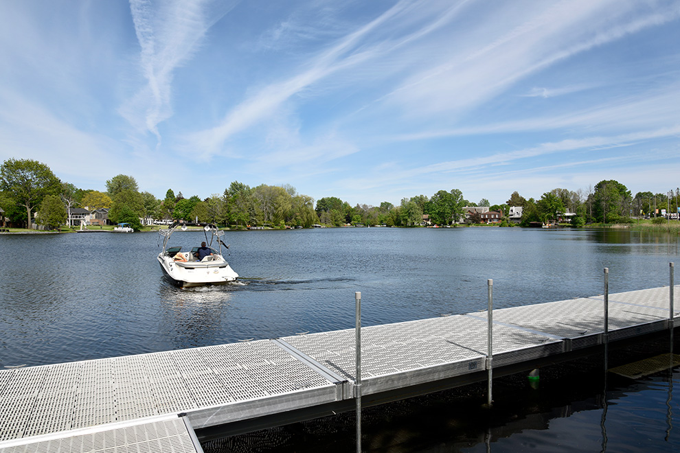 Man using a boat in lake in Mahogany, Manotick - a community by Minto Communities