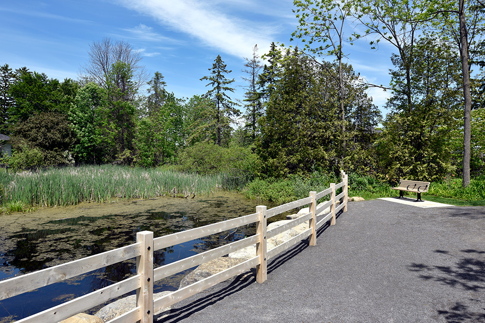 A bench to sit near water in Manotick - located near Mahogany, a community by Minto Communities