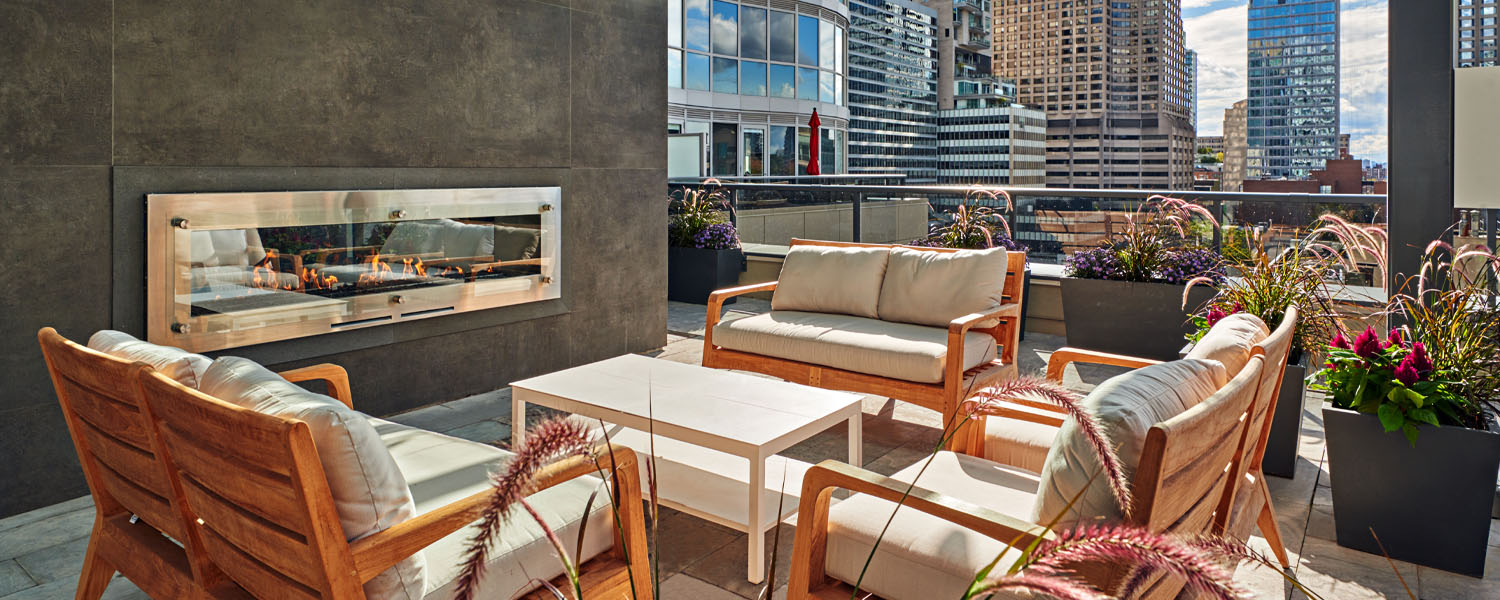 Rooftop patio and fireplace at Minto Yorkville Park. Condos in Yorkville, Toronto