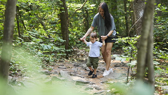 mother and son walking through march conservation area