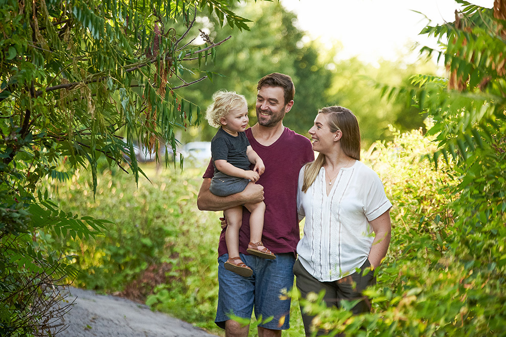 Couple walking on a path with young son