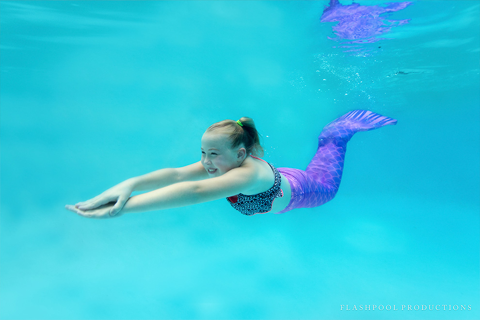 Girl swimming with mermaid tail