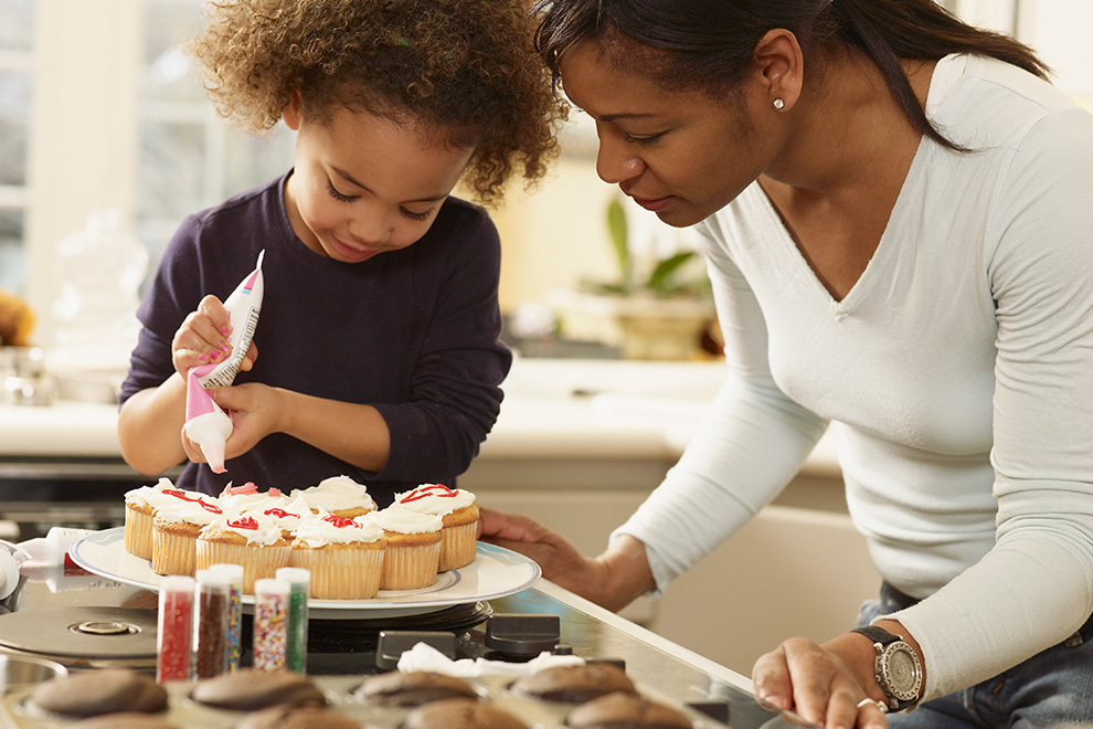 Mother and daughter making cupcakes