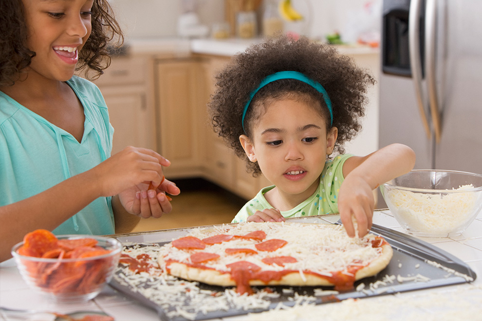 Kids making pizza at home