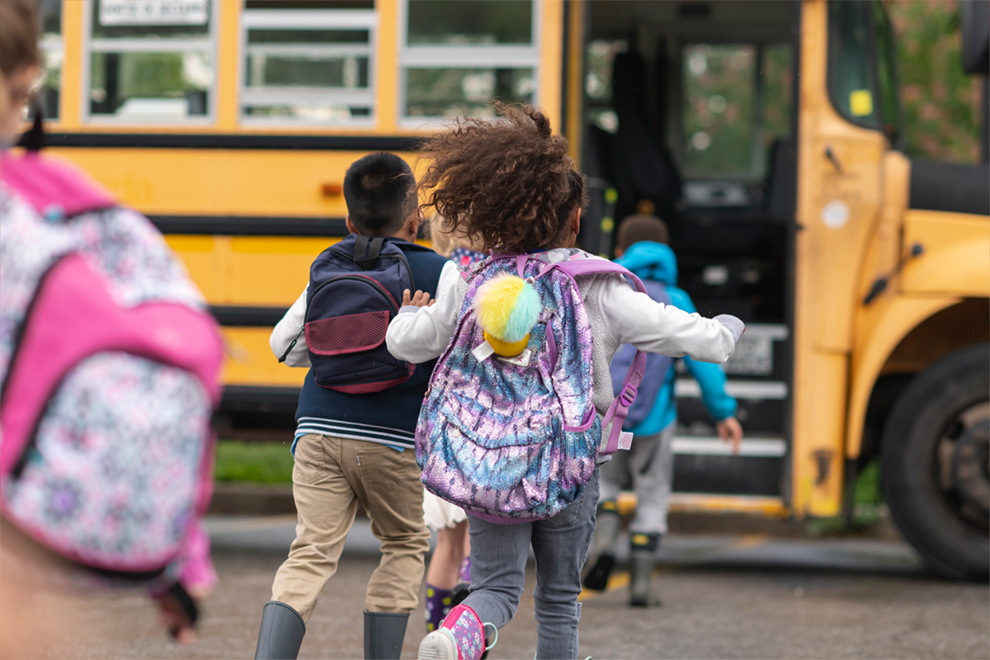 Photo of kids running to the bus