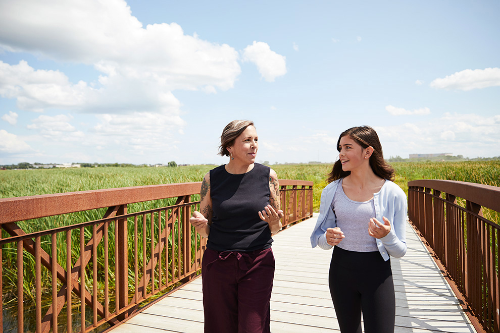 Walking outside on bridge in Carp River Conservation Area