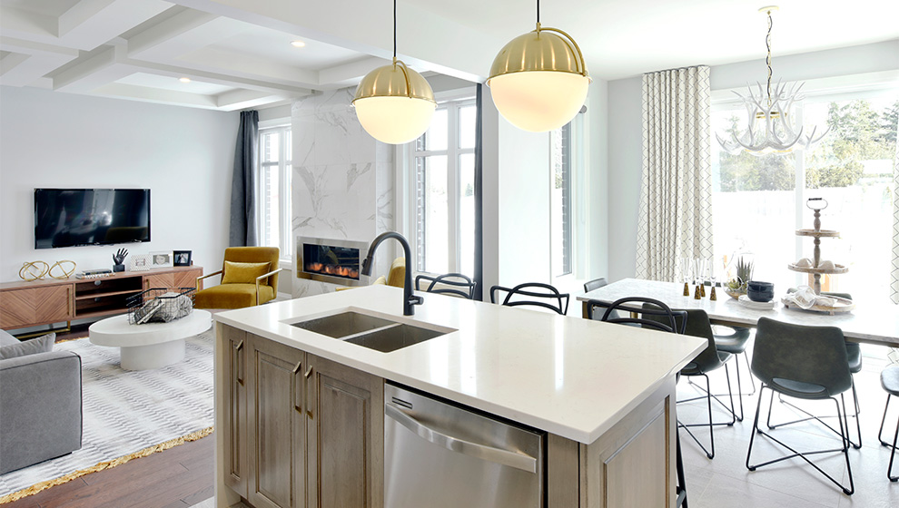 Kitchen island and living room of townhome in Ottawa. How to choose the Mahogany home that is right for you, Minto Communities.