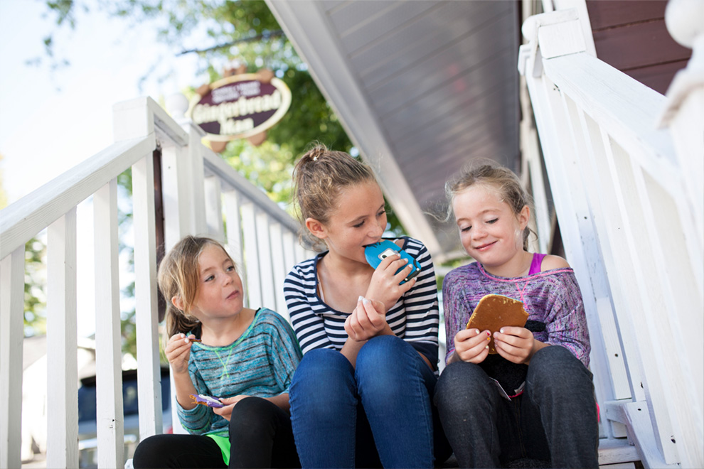 Girls sitting on a step eating cookies