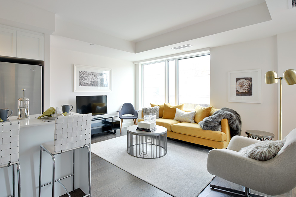 An interior shot of the brightly-lit Elmdale unit in Minto Beechwood, showing the eat-in kitchen and adjoining sitting room.