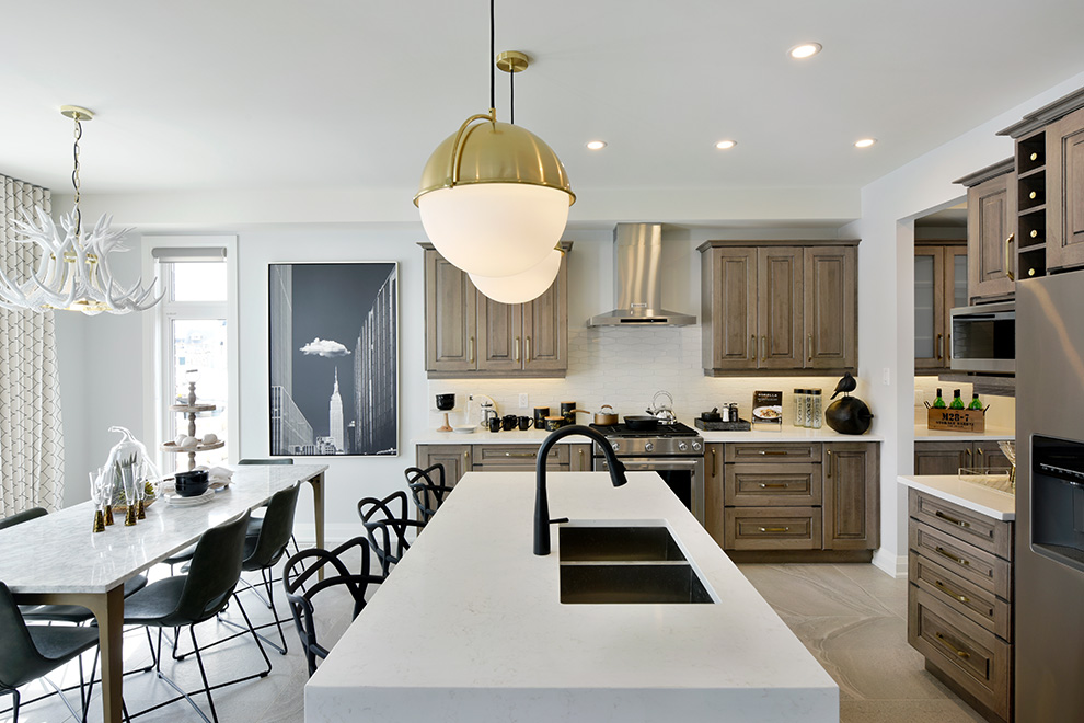 The brightly-lit open-concept kitchen of the Elderberry Single Family Home.