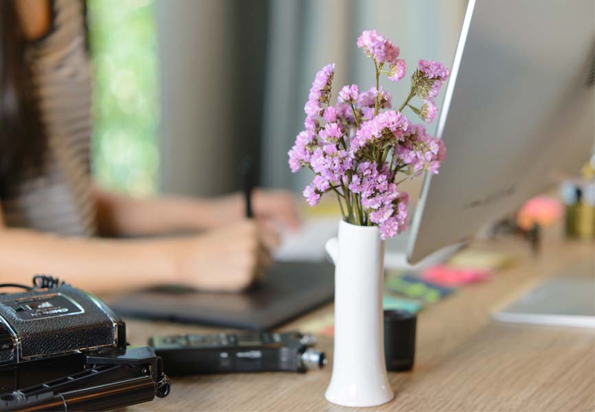 Flowers next to a laptop