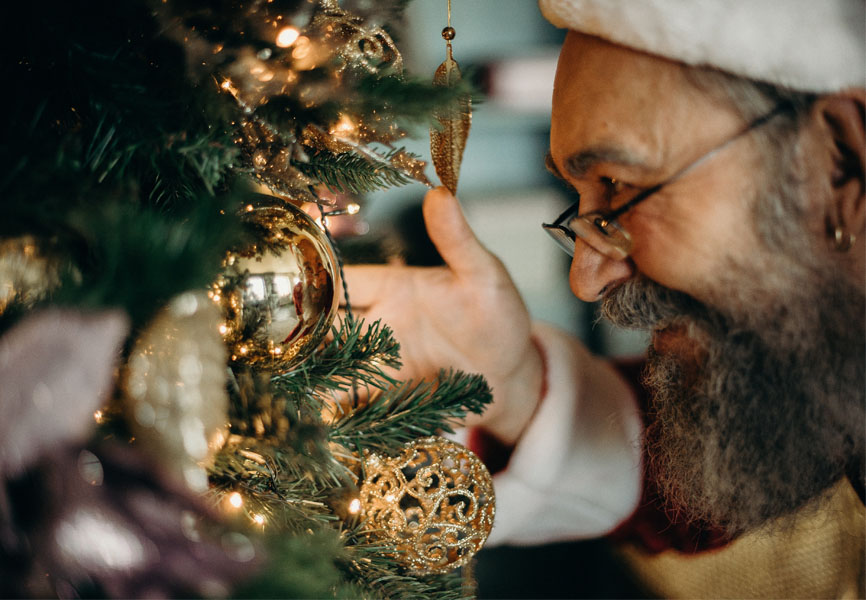 Santa looking at a Christmas ornament 