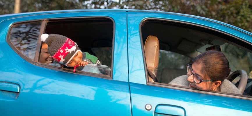 mom and daughter in a blue car together