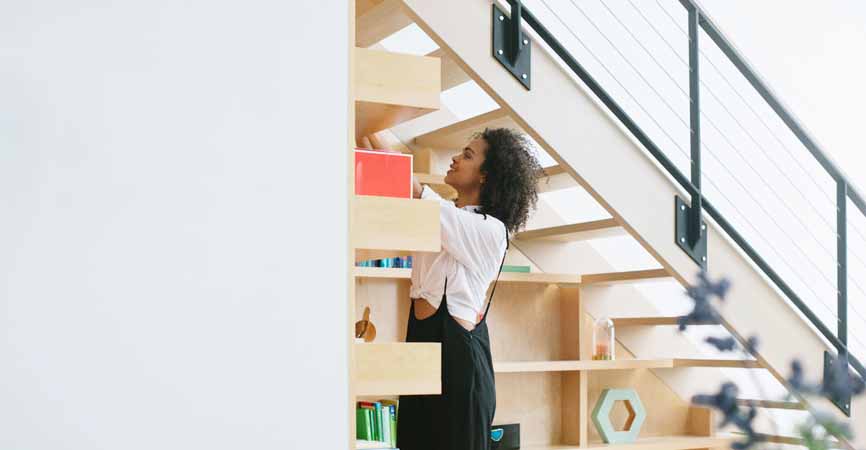 girl rearranging shelves in her home