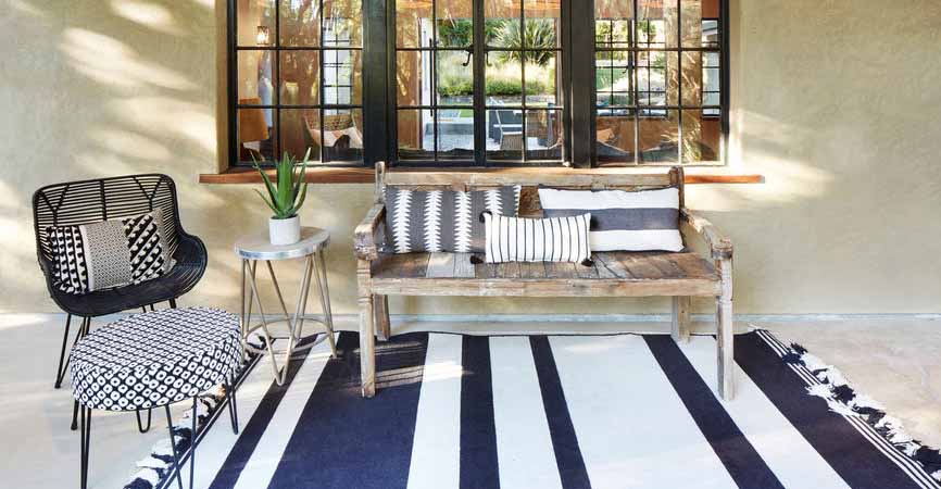 pillows and plants on a front porch