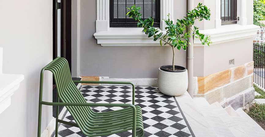 porch with plant, chair and checkered floors
