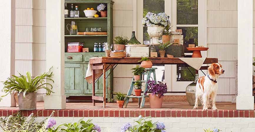 dog on porch with lots of cute antique furniture
