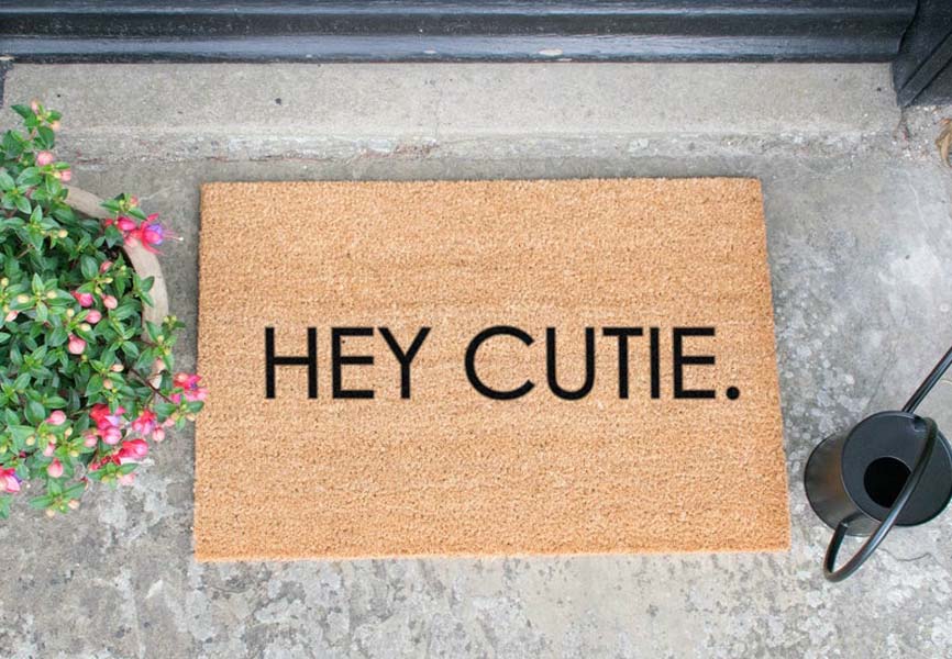 Front door mat with the word Hey Cutie written on it