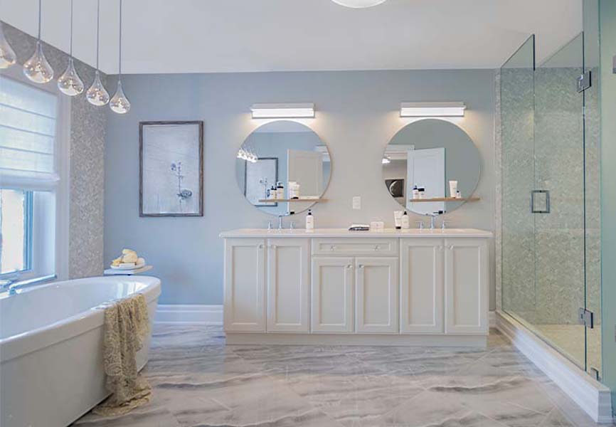 White marble floors in a bathroom with white counter tops and a double sink 