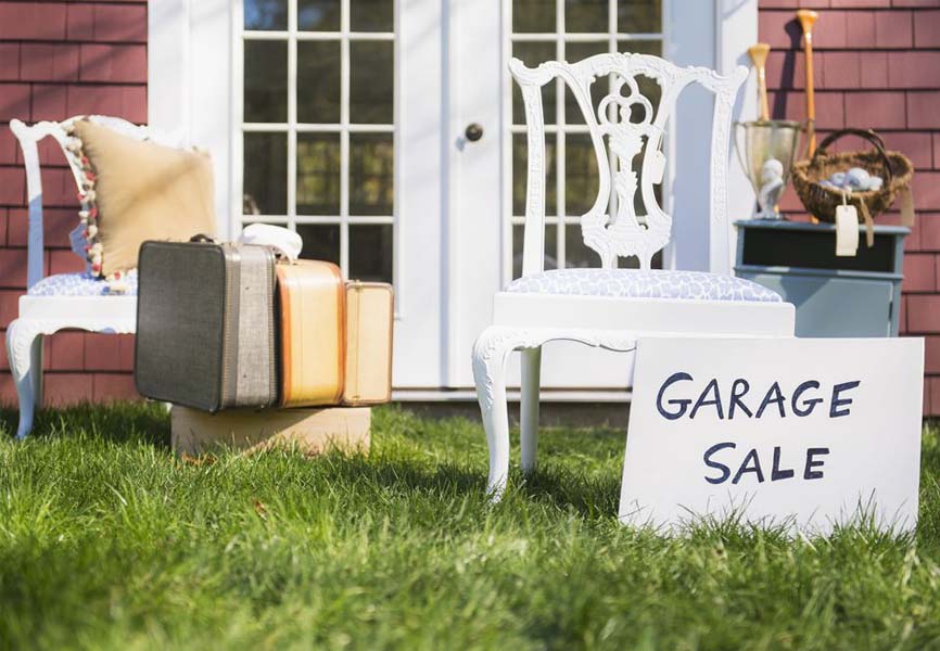 Garage Sale sign in front of old furniture