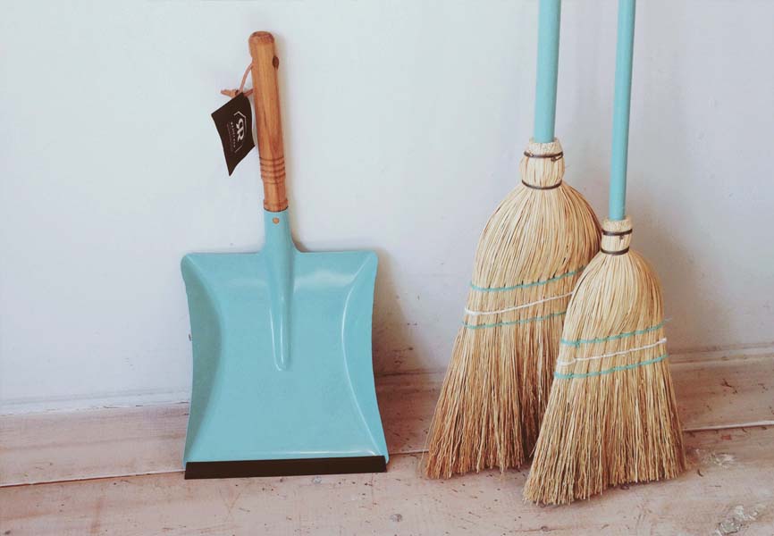 two brooms with blue handles with a blue pan
