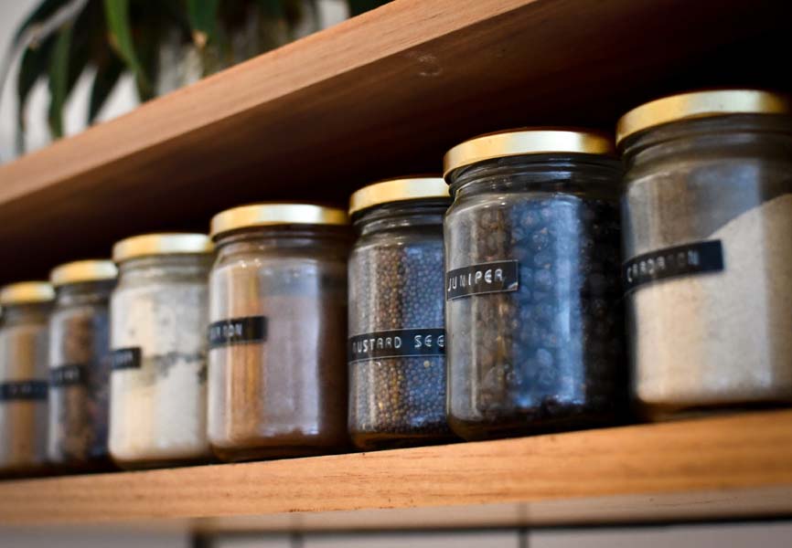 Shelf lined with labeled jars