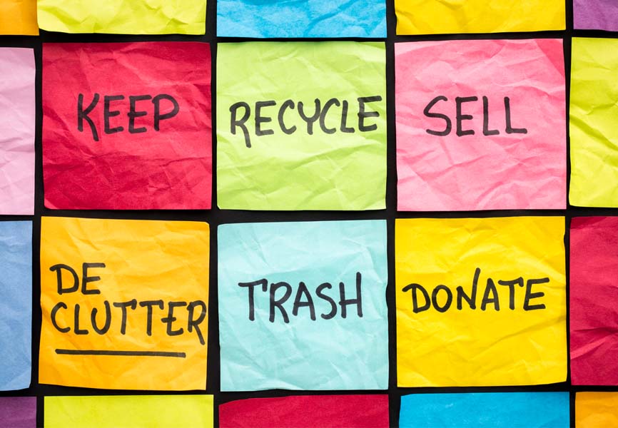 Post it notes with the words declutter, keep, recycle, sell, trash and donate written on them
