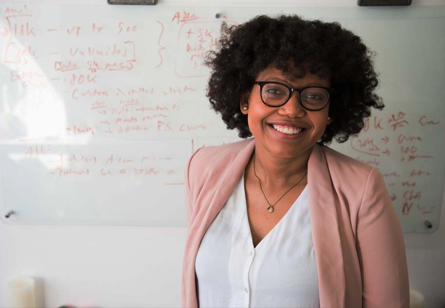 A teacher standing in front of her white board