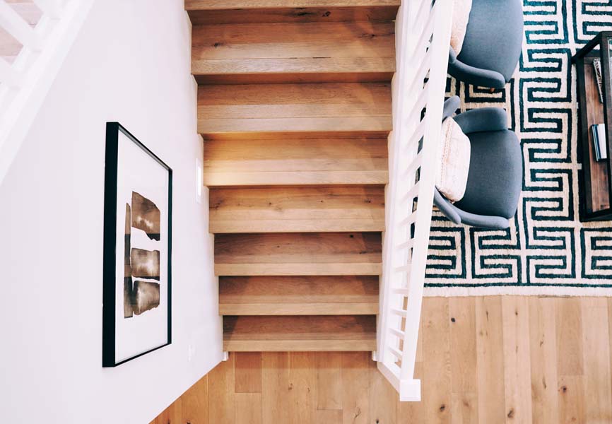 light coloured floors on stairs and white railing 