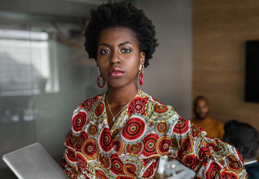 A woman standing in front of her colleagues during a meeting