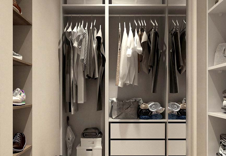 Walk in closet with lots of clothes