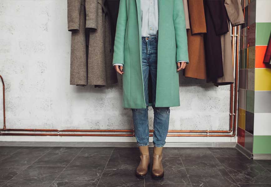 Woman wearing a long teal coat