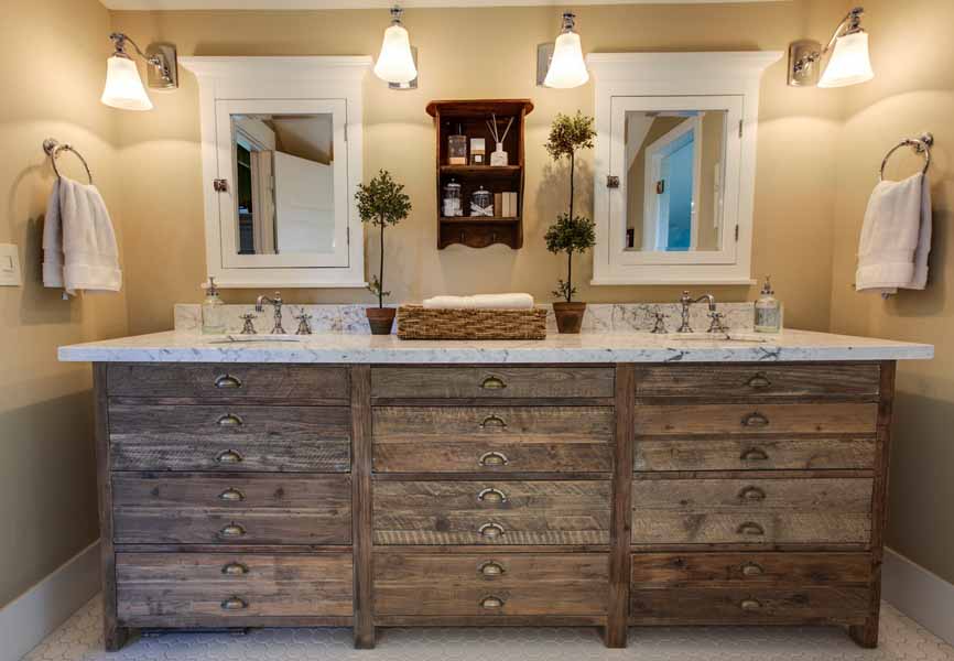 bathroom with wood vanity and plants on the counter