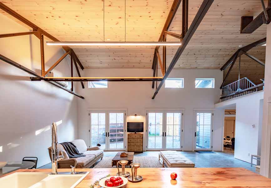 open space kitchen and living room with wood accents