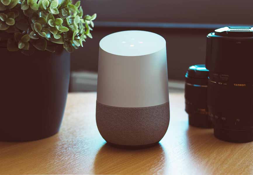 smart home technology on table beside camera and plant