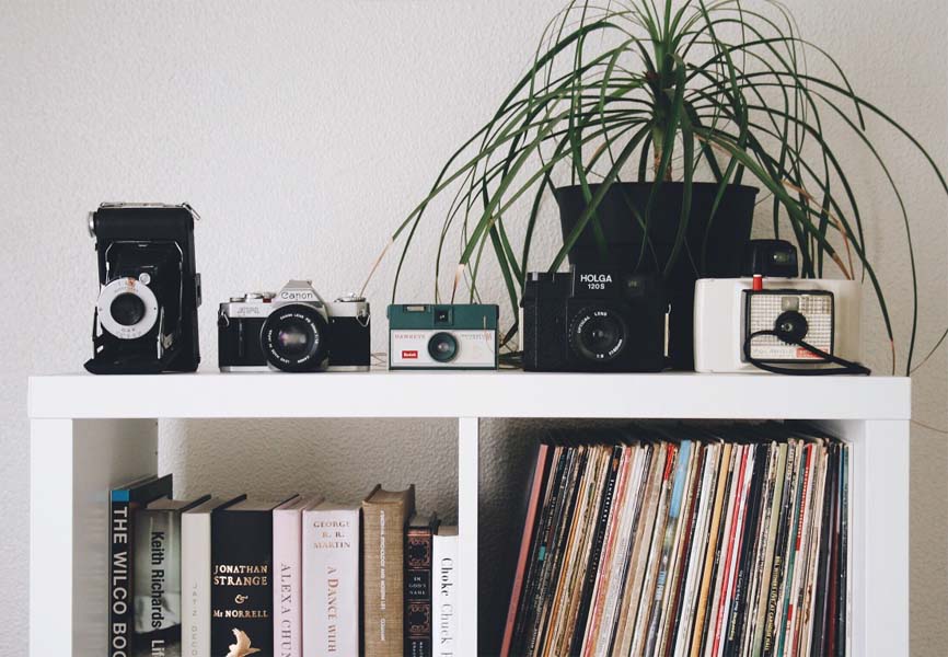 cameras records and books organized on shelf