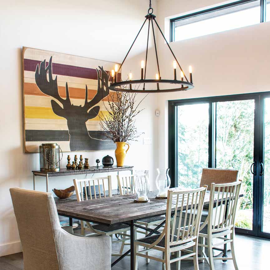 cottagey dining room with beautiful pendant light and artwork on the walls