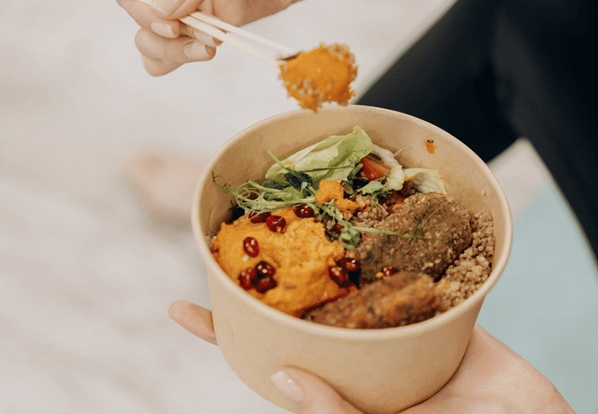 Person eating healthy grain bowl