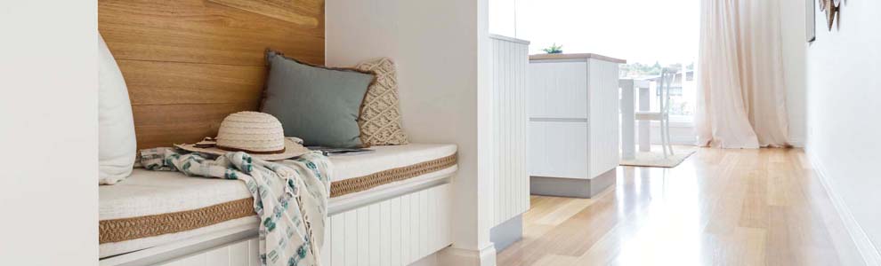 A built-in nook located at the front of the house with white padded seating