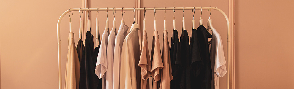Neutral clothing hanging on a rack