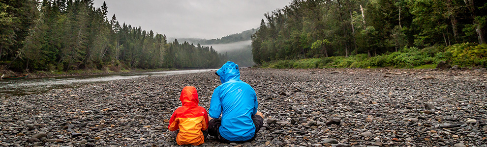 Father and son sitting in national park