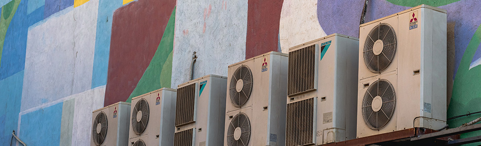 Air conditioning units on a colourful wall