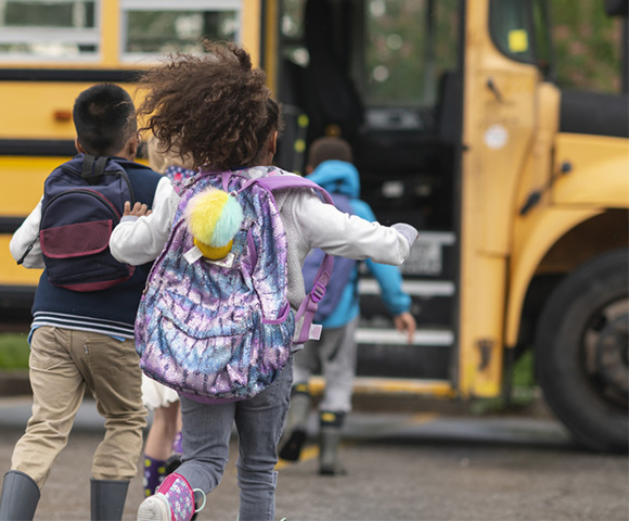 Child running to school bus in Barrhaven